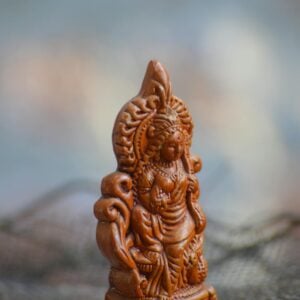 close up shot of a wooden statuette of hindu god lakshmi