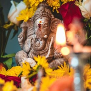 ganesha elephant surrounded by yellow flowers