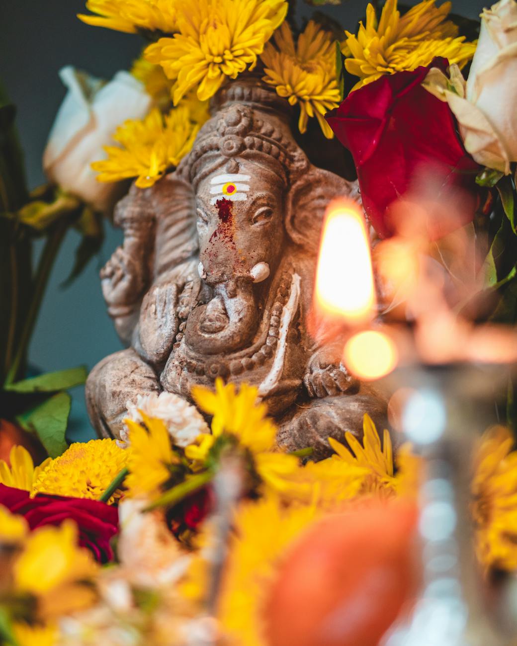 ganesha elephant surrounded by yellow flowers